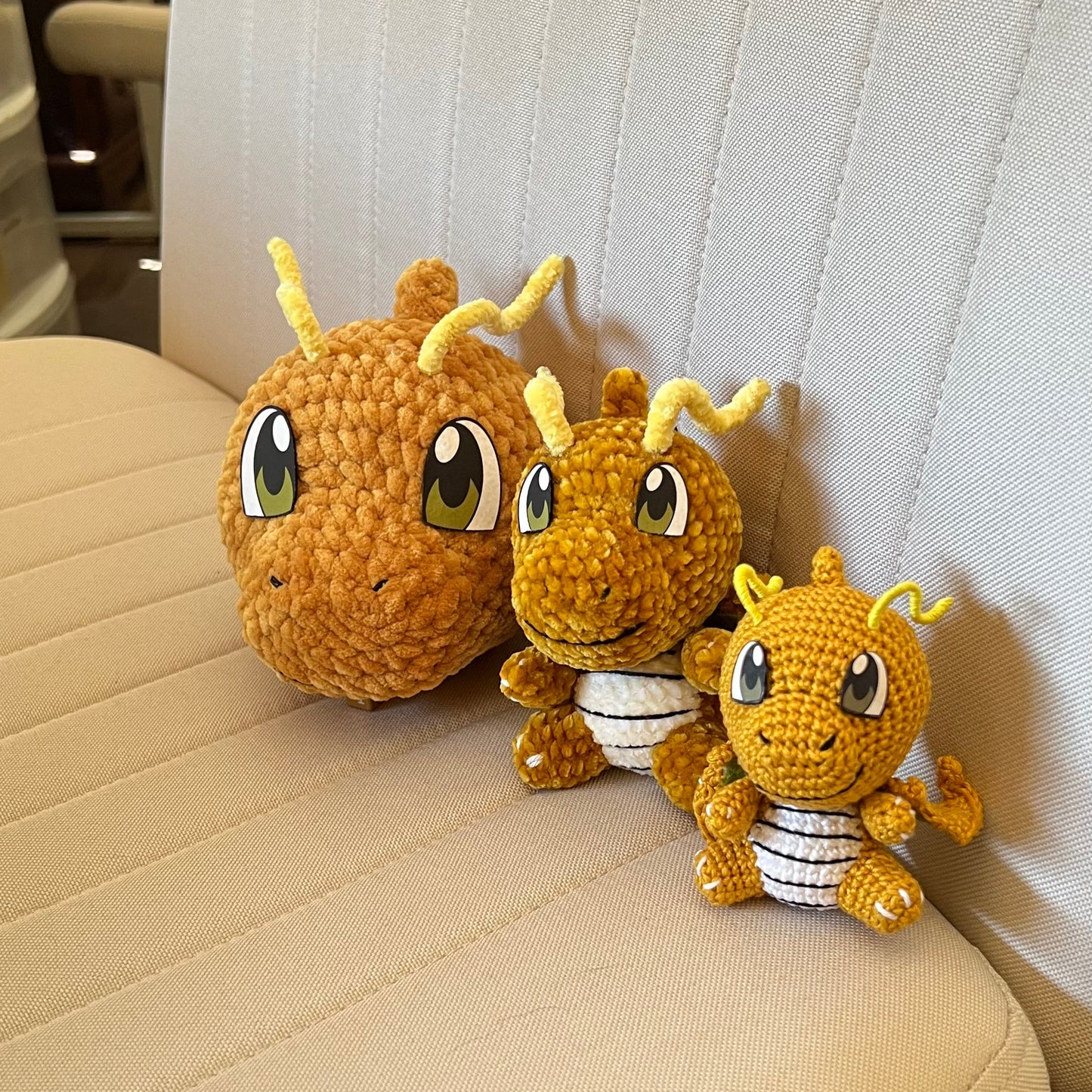 Flying yellow dragon amigurumi plush shown from multiple sizes