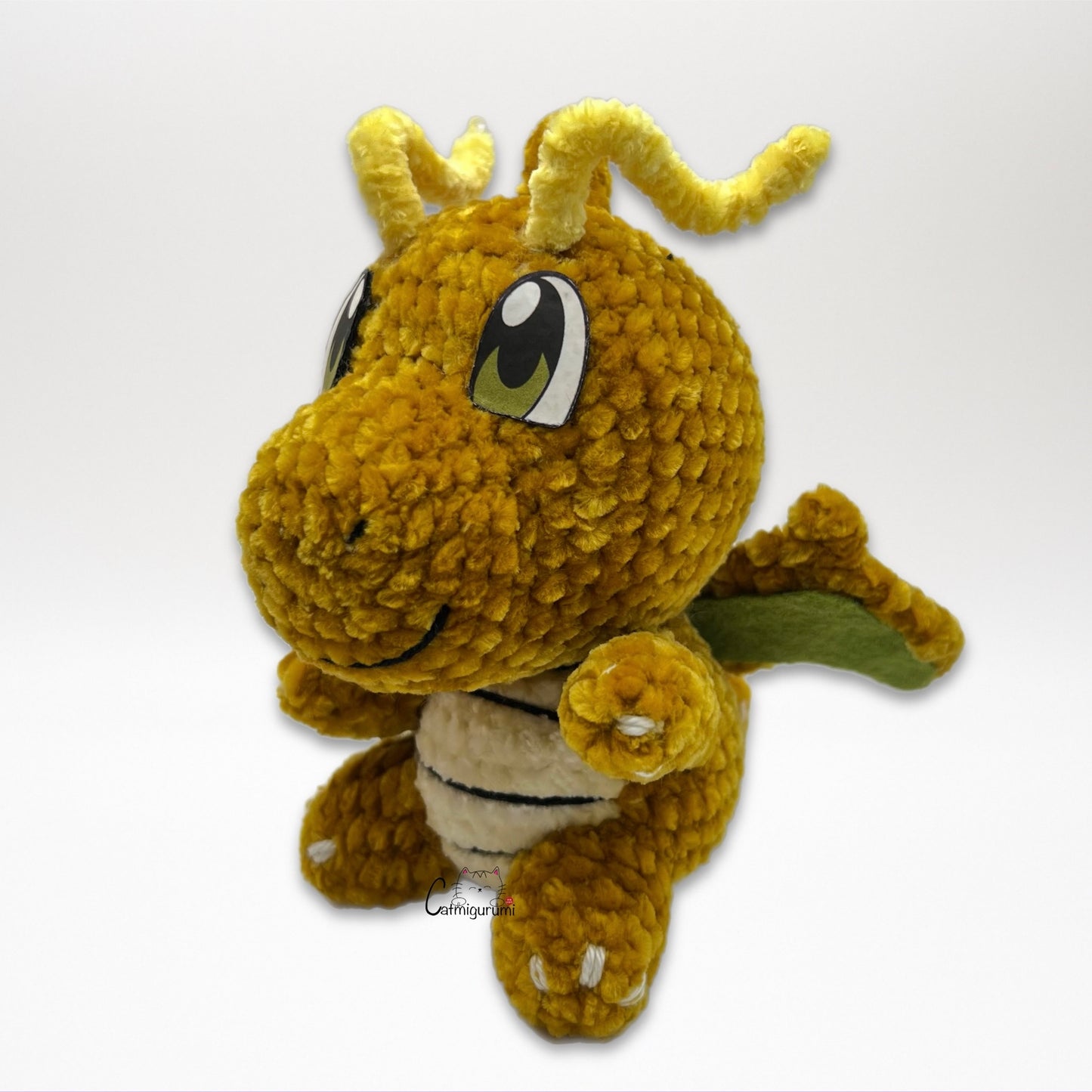 Left side view of flying yellow dragon amigurumi crochet plush